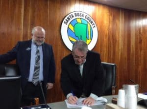 Triumph Chair Don Gaetz and GCSC President John Holdnak sign grant award agreement.